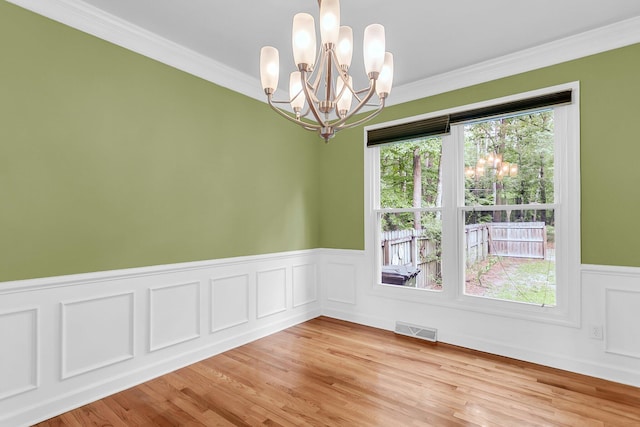 320 Compton Xing, Summerville, SC 29485 - unfurnished room with a chandelier, wainscoting, ornamental molding, and light wood-style floors