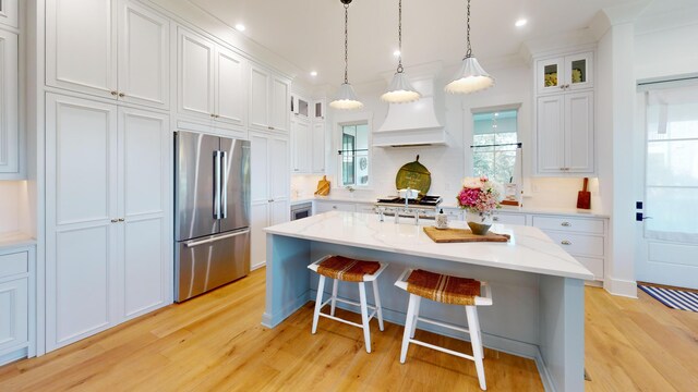 2312 Rushland Landing Rd, Johns Island, SC 29455 - kitchen with high end fridge, light wood finished floors, white cabinets, a breakfast bar area, and recessed lighting