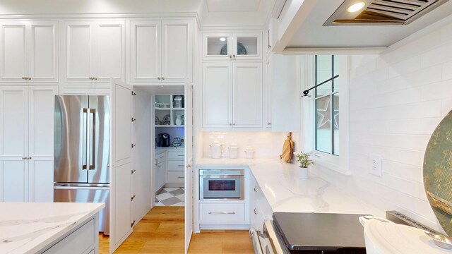 2312 Rushland Landing Rd, Johns Island, SC 29455 - kitchen featuring stainless steel appliances, white cabinets, light stone countertops, light wood-type flooring, and glass insert cabinets