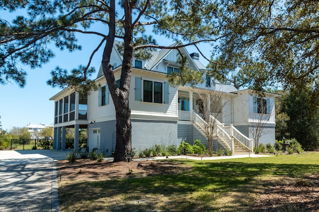2312 Rushland Landing Rd, Johns Island, SC 29455 - view of front of home with stairway, concrete driveway, a porch, and a front yard