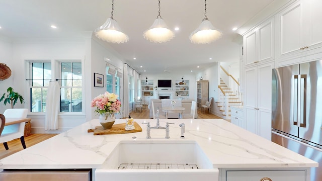 2312 Rushland Landing Rd, Johns Island, SC 29455 - kitchen with high end fridge, an island with sink, open floor plan, a sink, and light wood-style floors