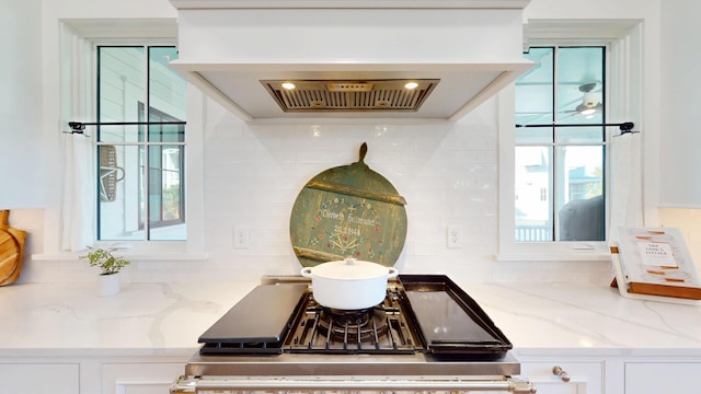 2312 Rushland Landing Rd, Johns Island, SC 29455 - kitchen view of backsplash, white cabinetry, and light stone counters