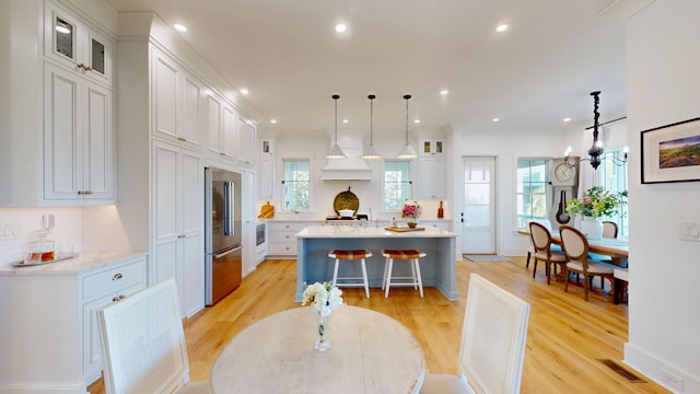 2312 Rushland Landing Rd, Johns Island, SC 29455 - kitchen with high end fridge, light countertops, a kitchen island, light wood-style floors, and recessed lighting