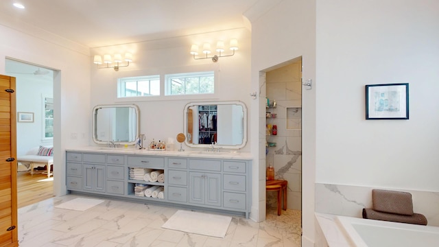 2312 Rushland Landing Rd, Johns Island, SC 29455 - ensuite bathroom featuring marble look tiles, a tub, and double vanity