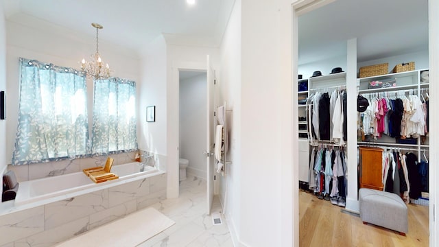 2312 Rushland Landing Rd, Johns Island, SC 29455 - bathroom featuring a garden tub, toilet, a chandelier, and a walk in closet