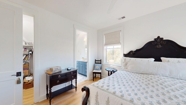 2312 Rushland Landing Rd, Johns Island, SC 29455 - bedroom featuring light wood-type flooring, connected bathroom, and a spacious closet