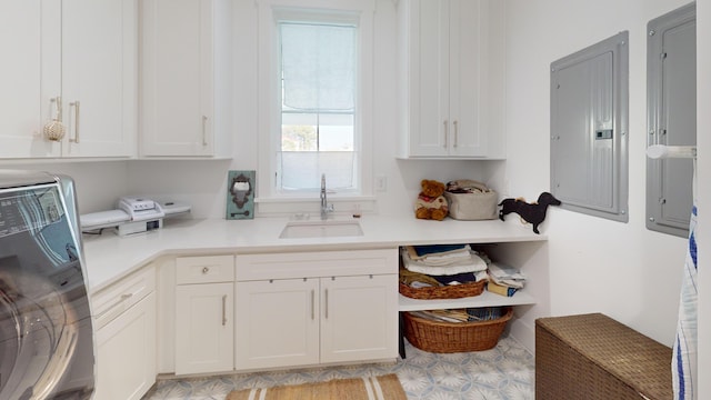 2312 Rushland Landing Rd, Johns Island, SC 29455 - kitchen featuring washer / clothes dryer, a sink, electric panel, light countertops, and white cabinetry