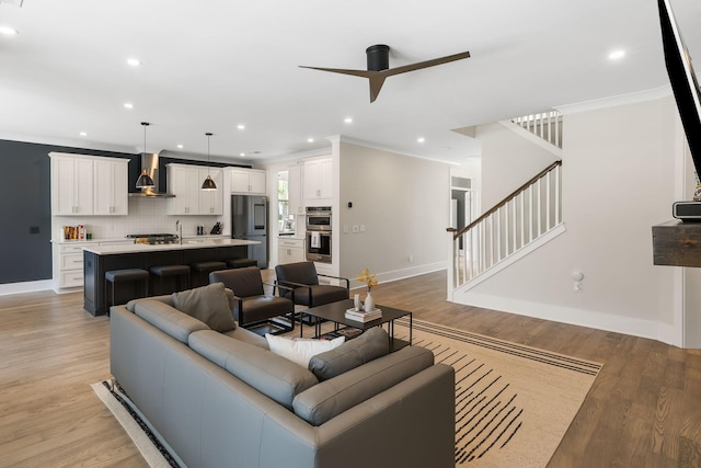 1234 Captain Rivers Dr, Charleston, SC 29412 - living room with ceiling fan, crown molding, baseboards, light wood finished floors, and stairway