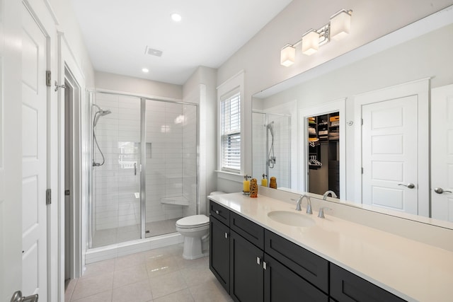 1234 Captain Rivers Dr, Charleston, SC 29412 - full bathroom with vanity, tile patterned flooring, a shower stall, a walk in closet, and toilet