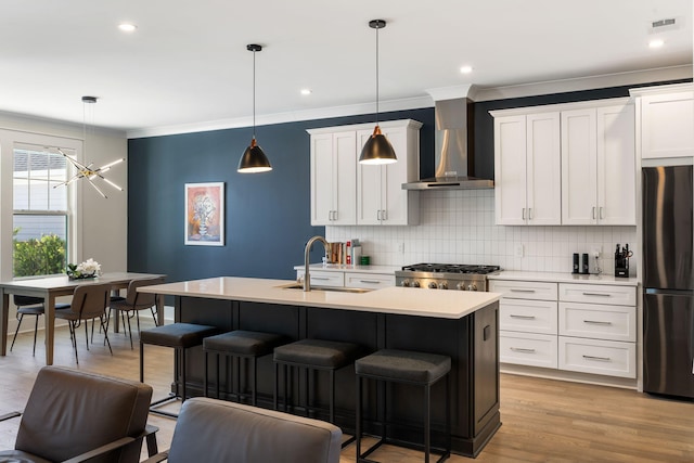 1234 Captain Rivers Dr, Charleston, SC 29412 - kitchen with freestanding refrigerator, wall chimney exhaust hood, a sink, decorative backsplash, and light countertops