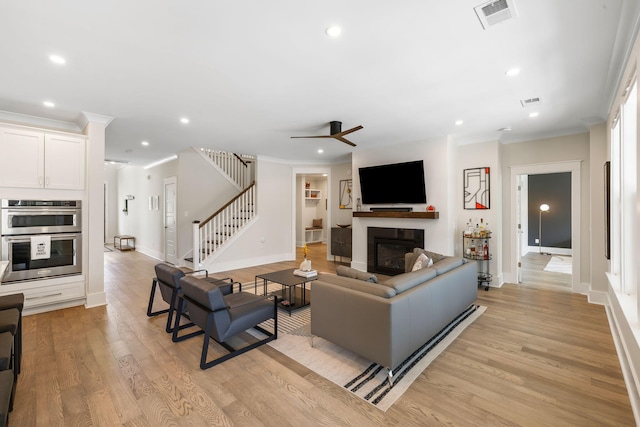 1234 Captain Rivers Dr, Charleston, SC 29412 - living room featuring a glass covered fireplace, ornamental molding, a ceiling fan, recessed lighting, and light wood finished floors