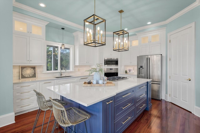 kitchen with blue cabinets, white cabinetry, stainless steel appliances, and a sink