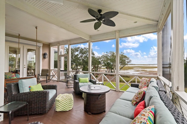 sunroom / solarium with beamed ceiling and ceiling fan