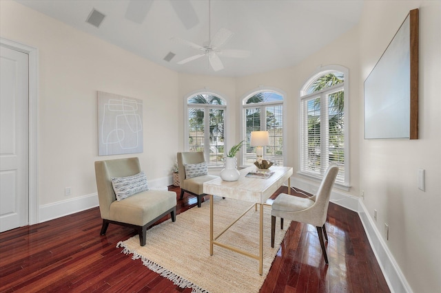 interior space with baseboards, visible vents, ceiling fan, and wood finished floors