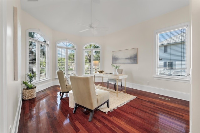 dining area featuring a ceiling fan, visible vents, baseboards, and wood finished floors