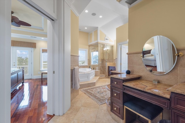 bathroom featuring ornamental molding, a garden tub, a high ceiling, vanity, and recessed lighting