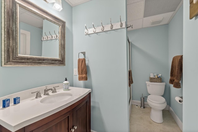 bathroom featuring visible vents, baseboards, toilet, tile patterned flooring, and vanity