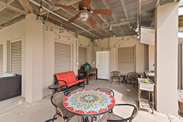 view of patio with outdoor dining area and a ceiling fan