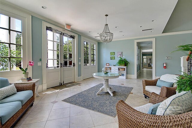 interior space featuring light tile patterned floors, visible vents, ornamental molding, and a notable chandelier