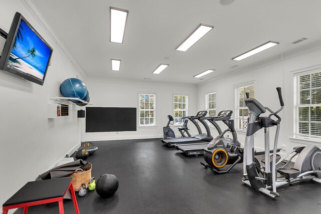 gym with visible vents, crown molding, and baseboards