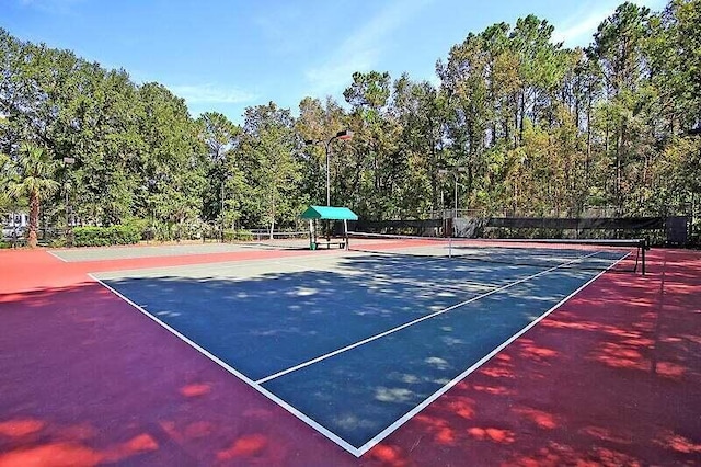 view of sport court featuring fence