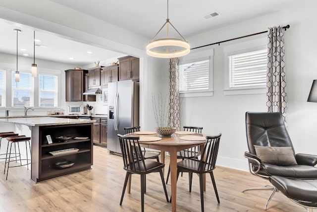 dining area with recessed lighting, light wood-style floors, visible vents, and baseboards