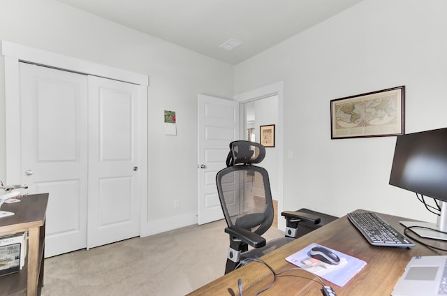 office area featuring baseboards and light colored carpet