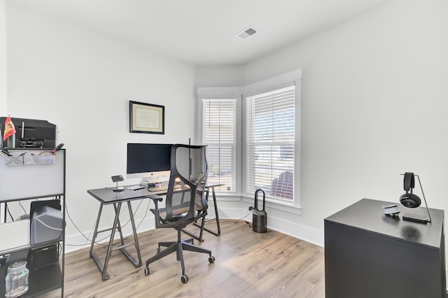 office area featuring wood finished floors, visible vents, and baseboards