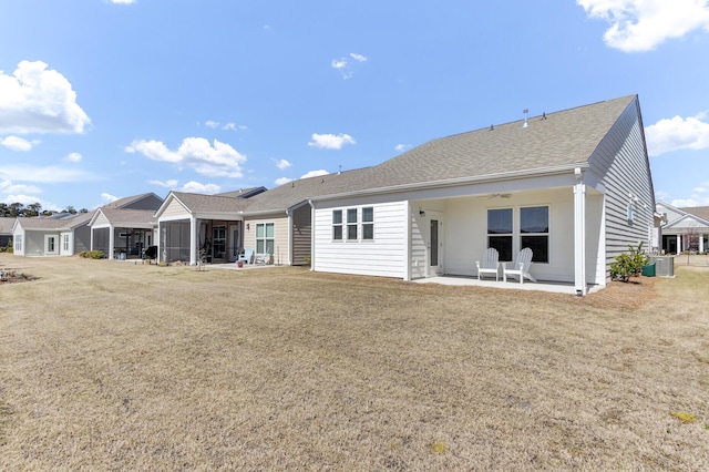 rear view of house featuring a shingled roof, ceiling fan, central AC, a sunroom, and a patio area