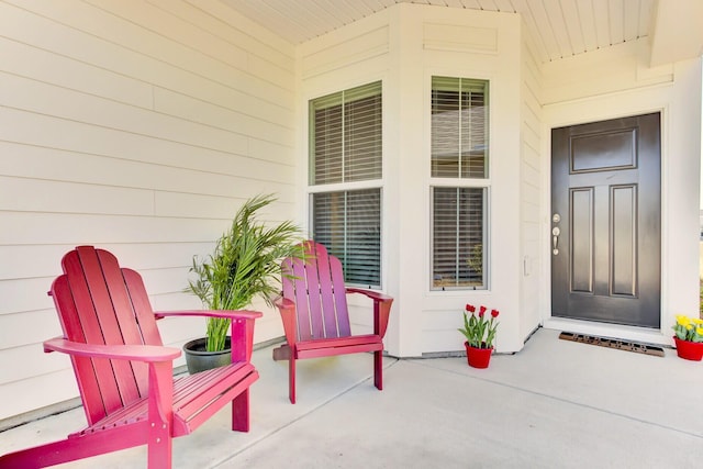 view of exterior entry with a patio area