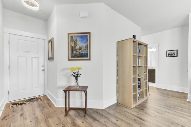 entryway featuring baseboards and wood finished floors