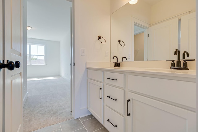 bathroom featuring a sink, double vanity, and tile patterned flooring