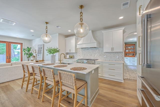 974 Cliffwood Dr, Mount Pleasant, SC 29464 - kitchen with high quality fridge, a sink, custom exhaust hood, a breakfast bar area, and recessed lighting