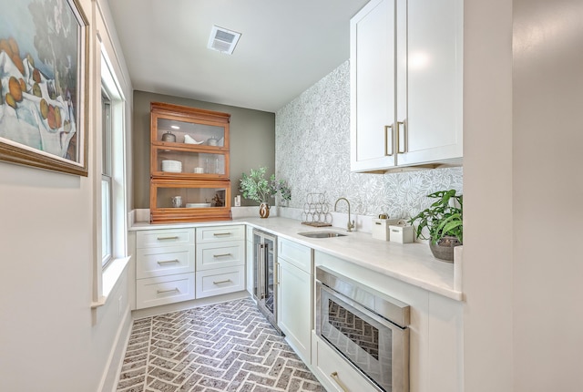 974 Cliffwood Dr, Mount Pleasant, SC 29464 - bar area featuring a sink, brick flooring, wine cooler, stainless steel microwave, and baseboards