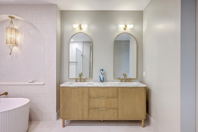 974 Cliffwood Dr, Mount Pleasant, SC 29464 - full bath featuring a freestanding bath, double vanity, tile patterned floors, tile walls, and baseboards