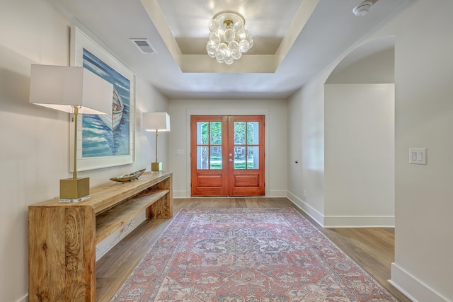 974 Cliffwood Dr, Mount Pleasant, SC 29464 - entryway with wood finished floors, french doors, a tray ceiling, a chandelier, and baseboards