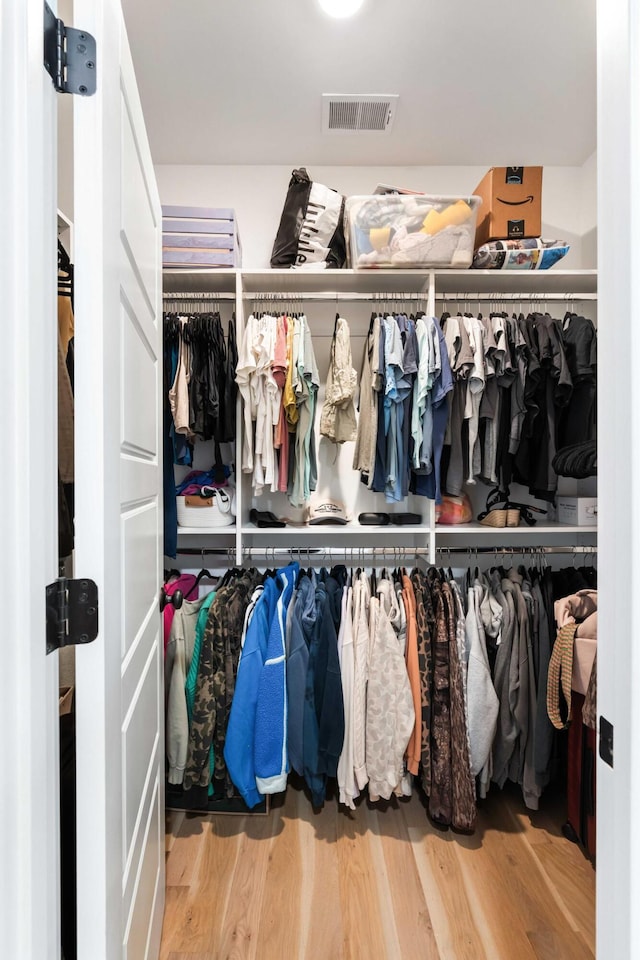 spacious closet featuring wood finished floors
