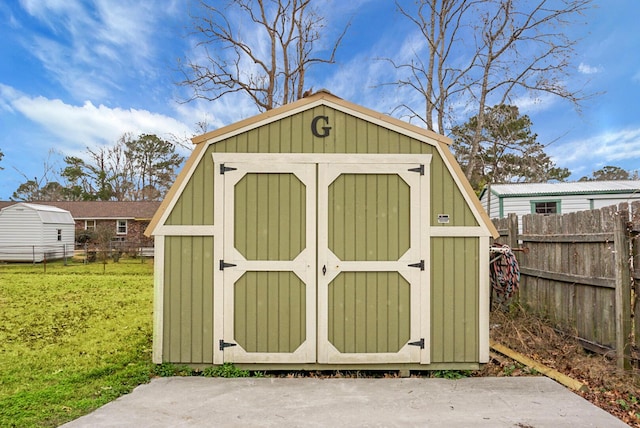 view of shed featuring fence