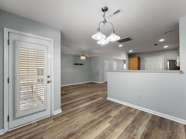 interior space featuring visible vents, ceiling fan, baseboards, and wood finished floors