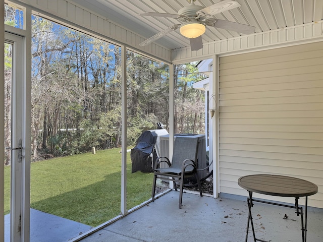 unfurnished sunroom with a ceiling fan