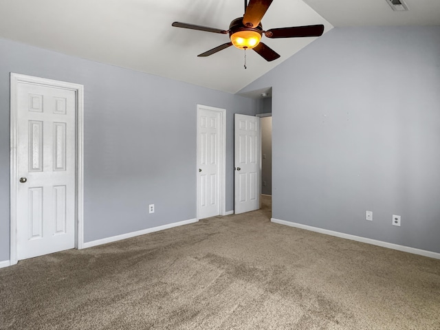 unfurnished bedroom with vaulted ceiling, carpet, a ceiling fan, and baseboards