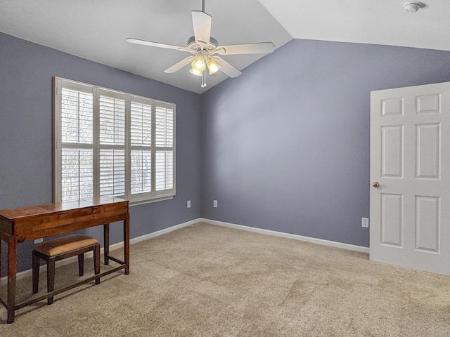 office area featuring lofted ceiling, baseboards, a ceiling fan, and light colored carpet