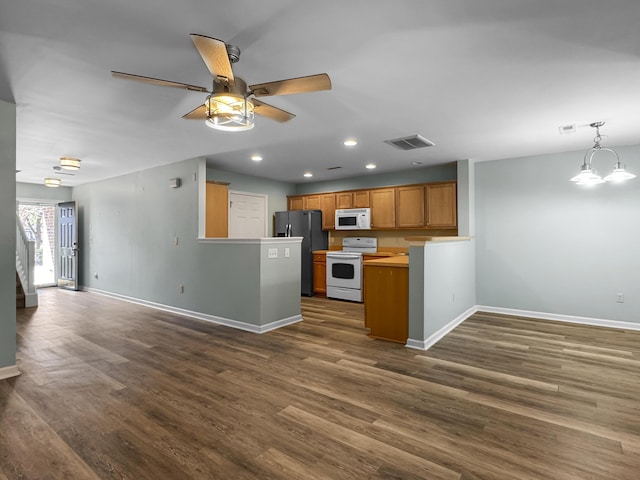 kitchen with decorative light fixtures, light countertops, visible vents, open floor plan, and white appliances