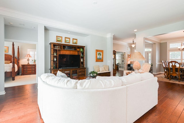 living room featuring wood-type flooring and ornamental molding