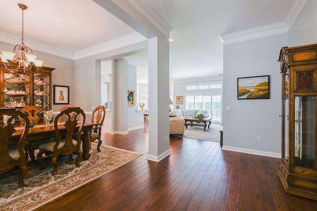 dining area with ornamental molding, a chandelier, and dark hardwood / wood-style flooring