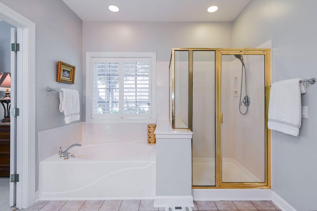 bathroom with tile patterned flooring and separate shower and tub