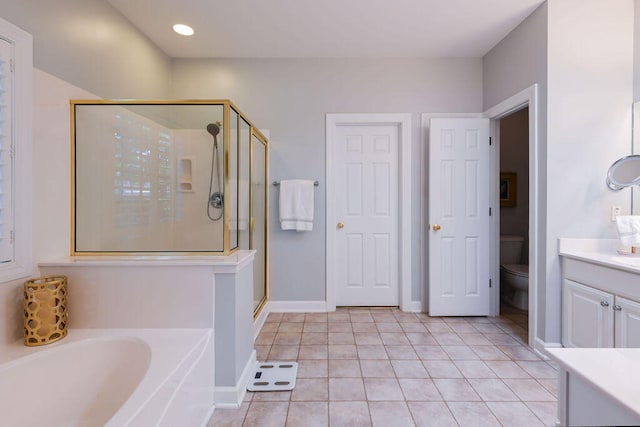 full bathroom with vanity, shower with separate bathtub, toilet, and tile patterned floors