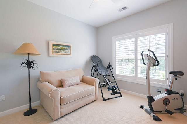 exercise area with light carpet, ceiling fan, and plenty of natural light