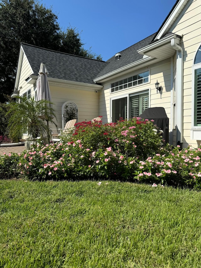 view of property exterior with a yard