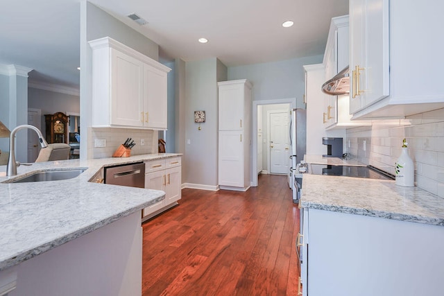 kitchen with dark hardwood / wood-style flooring, sink, white cabinetry, backsplash, and crown molding